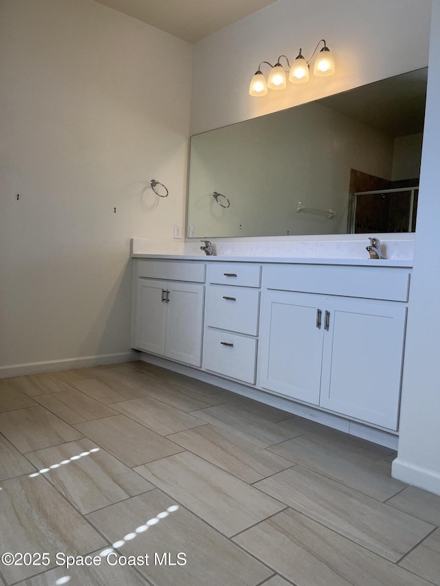 bathroom featuring an enclosed shower and vanity