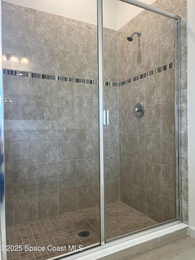 bathroom with a shower with door