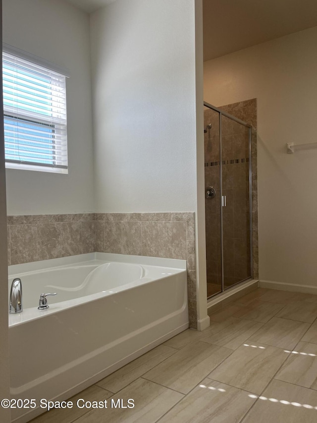 bathroom featuring shower with separate bathtub and tile patterned flooring