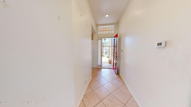 hall featuring light tile patterned flooring