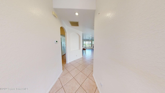 hall with light tile patterned floors