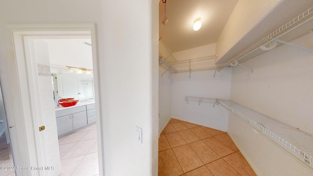 spacious closet featuring light tile patterned floors