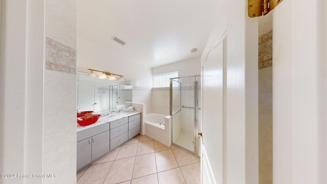 bathroom with tile patterned flooring, vanity, and shower with separate bathtub