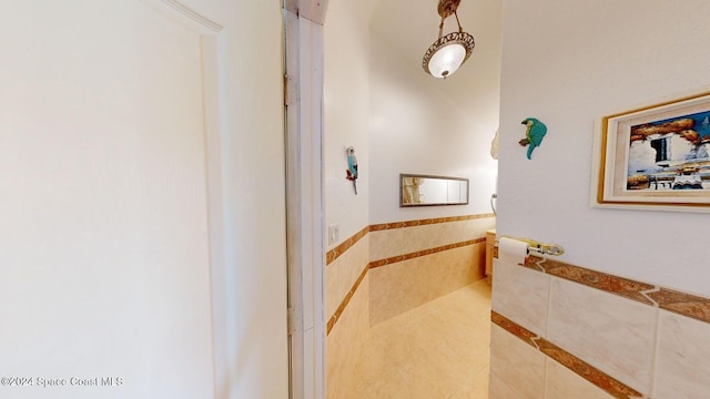 bathroom with tile walls