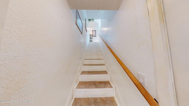 stairs featuring hardwood / wood-style flooring