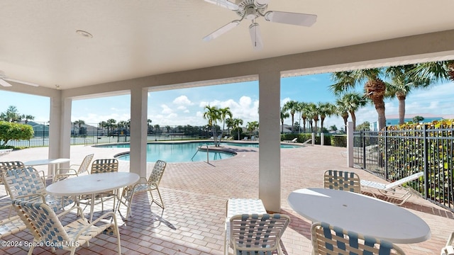 view of swimming pool with a patio area and ceiling fan