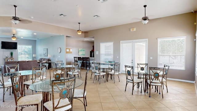 dining space featuring ceiling fan, a healthy amount of sunlight, and light tile patterned flooring