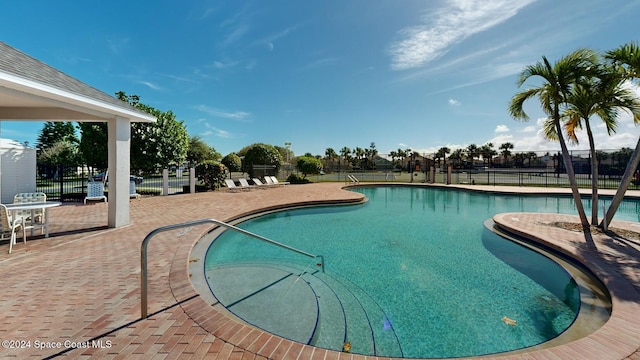 view of swimming pool with a patio