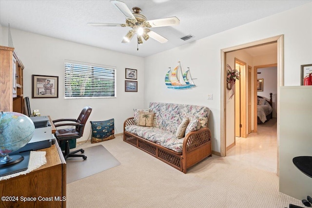 carpeted office featuring ceiling fan