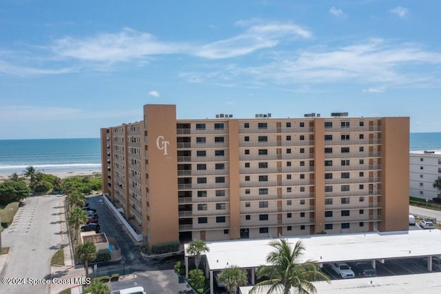 view of property with a view of the beach and a water view