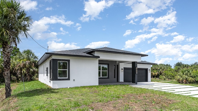 view of front of property with a garage and a front yard