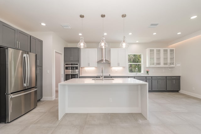 kitchen featuring decorative backsplash, appliances with stainless steel finishes, gray cabinetry, white cabinetry, and hanging light fixtures