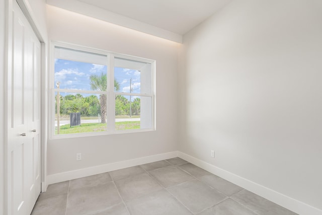 tiled empty room featuring a wealth of natural light