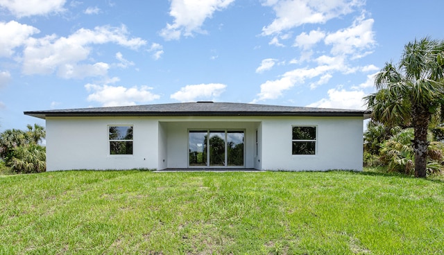 rear view of house with a yard and a patio