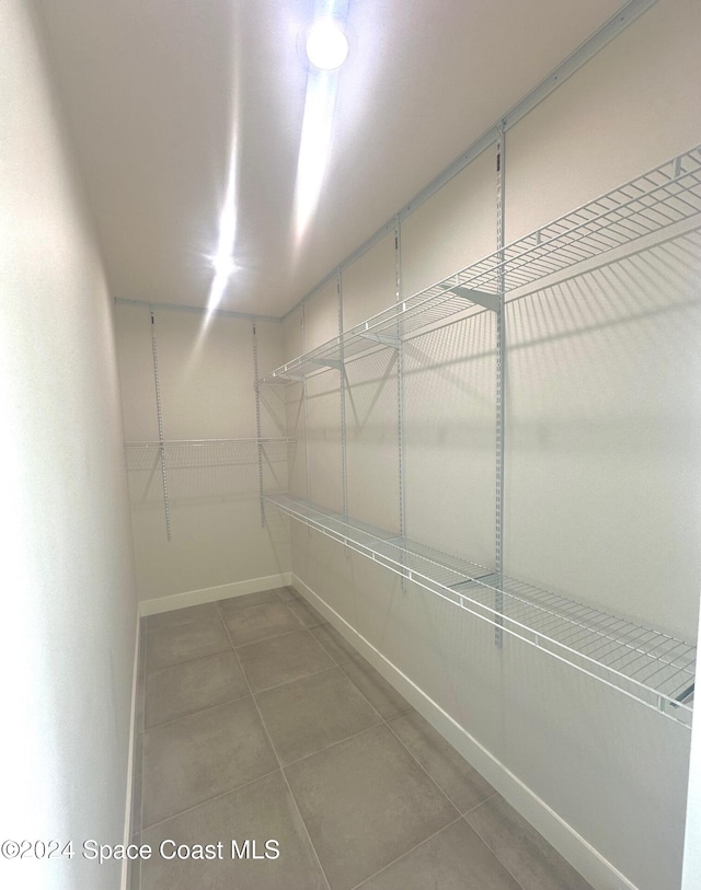 spacious closet featuring tile patterned floors