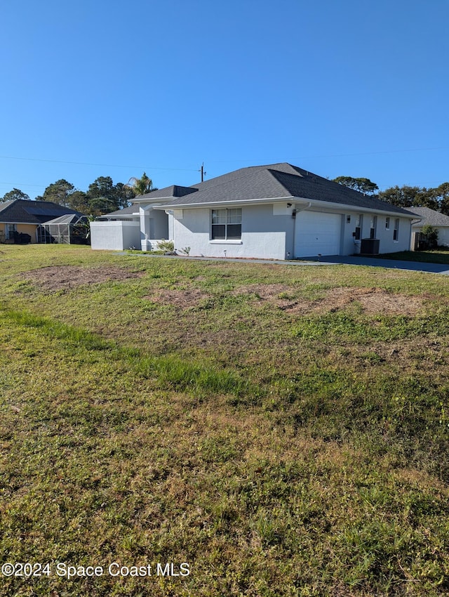 ranch-style home with a garage and a front lawn