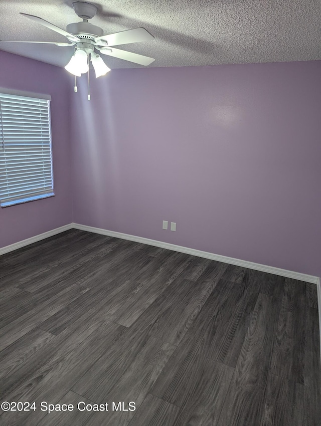 unfurnished room with ceiling fan, dark hardwood / wood-style flooring, and a textured ceiling