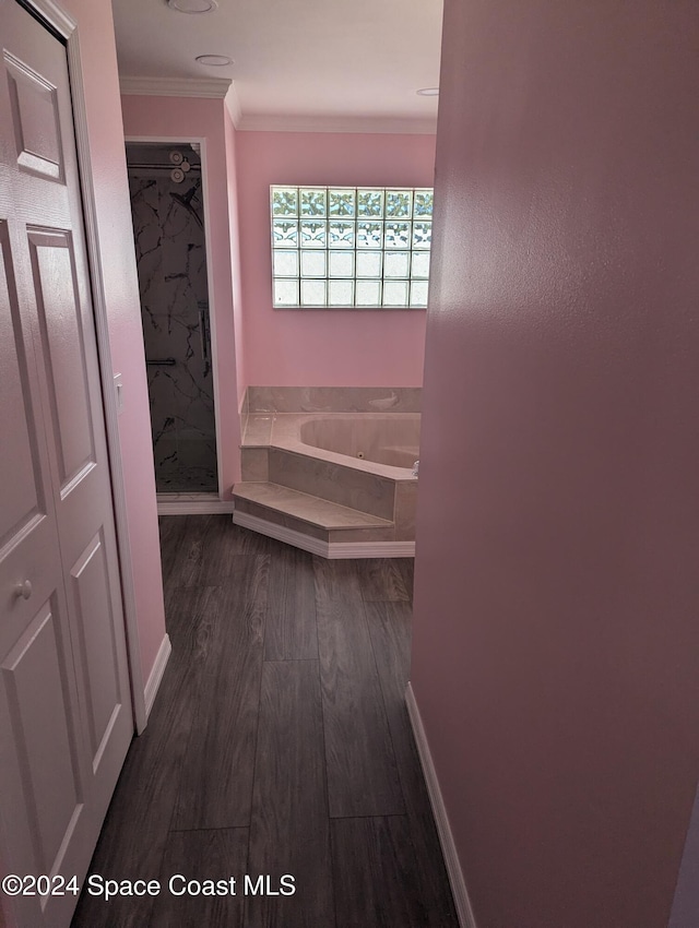 bathroom featuring hardwood / wood-style flooring, separate shower and tub, and ornamental molding