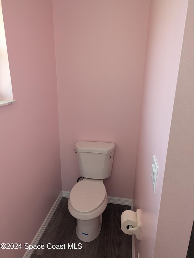 bathroom with hardwood / wood-style floors and toilet