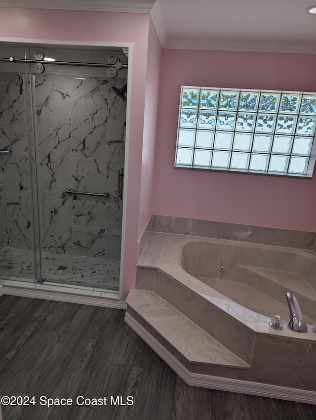 bathroom featuring hardwood / wood-style flooring, crown molding, and independent shower and bath