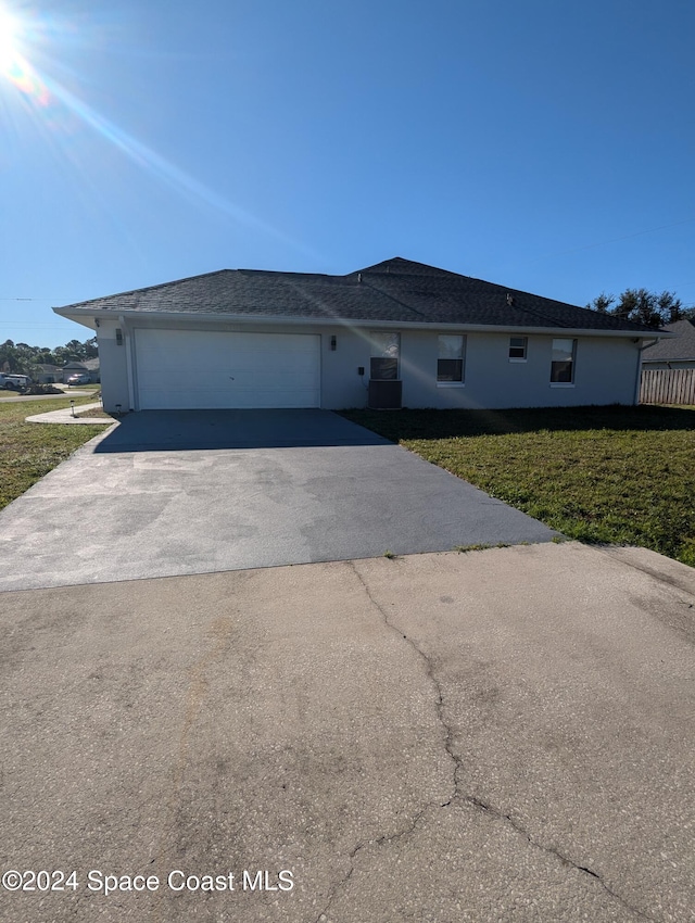 view of front of home with a garage and a front lawn