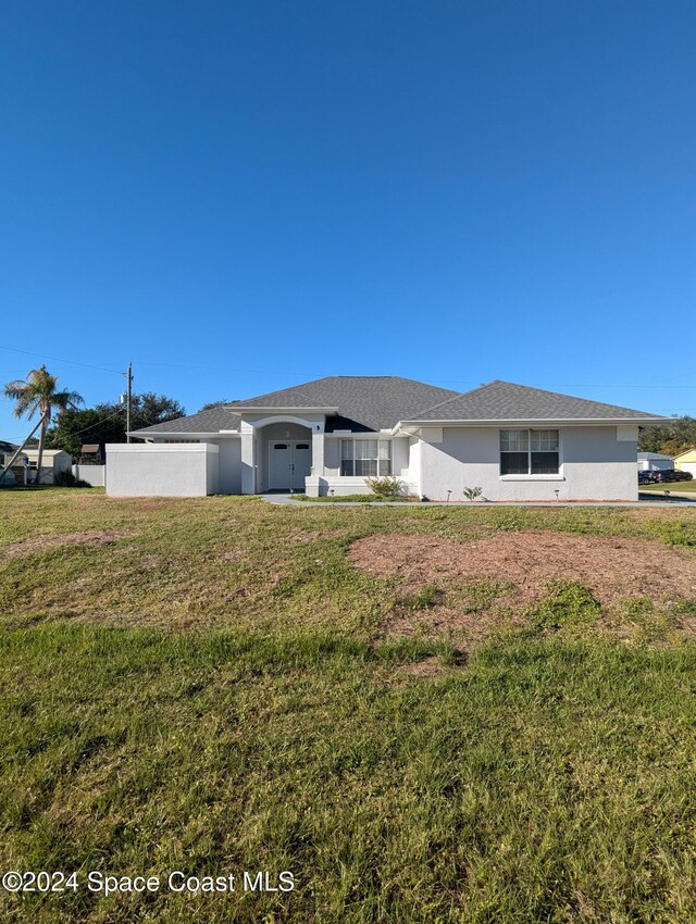 back of property featuring a lawn