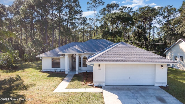 single story home with a garage and a front yard