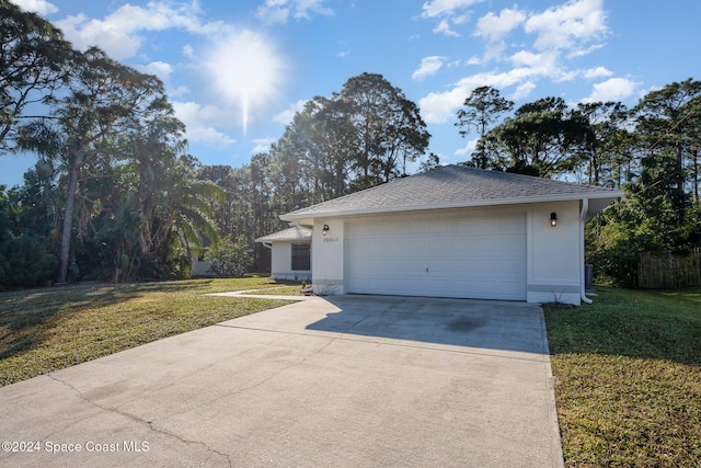 exterior space with a yard and a garage