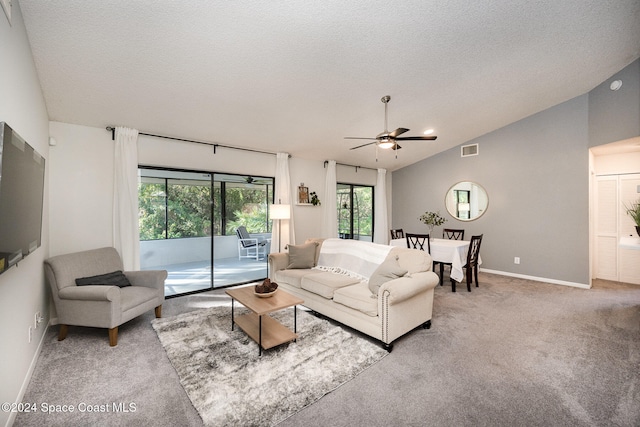 carpeted living room with a textured ceiling, ceiling fan, and lofted ceiling