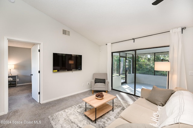 living room with light carpet, a textured ceiling, high vaulted ceiling, and ceiling fan