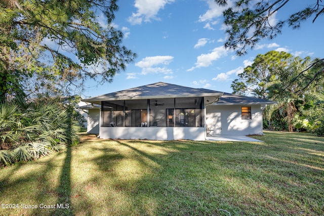 back of house featuring a sunroom and a yard