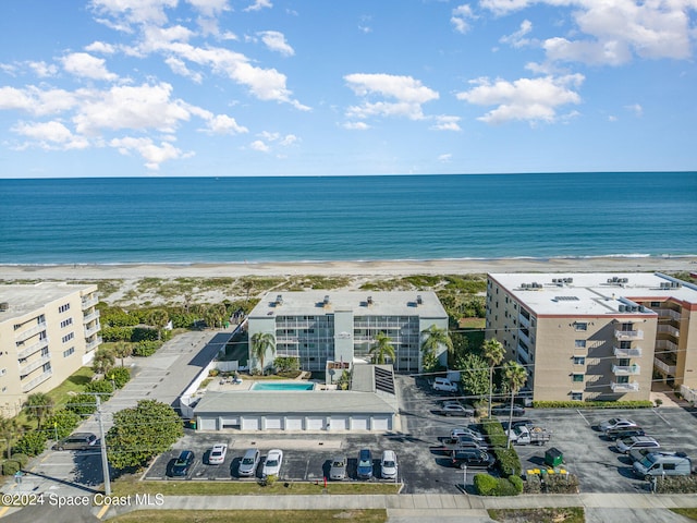 birds eye view of property with a beach view and a water view