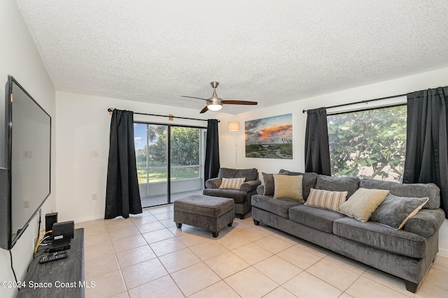 tiled living room featuring ceiling fan and a textured ceiling