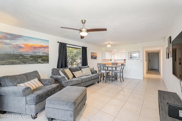 tiled living room with a textured ceiling and ceiling fan