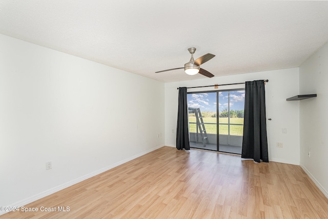 spare room featuring ceiling fan, a textured ceiling, and light hardwood / wood-style flooring