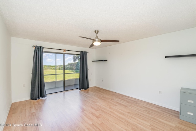 spare room with ceiling fan, a textured ceiling, and light hardwood / wood-style flooring