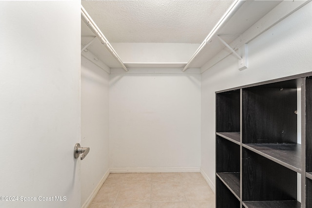 spacious closet with tile patterned floors