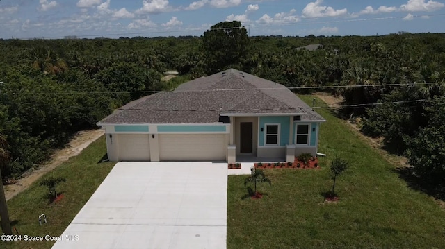 view of front facade with a front yard and a garage