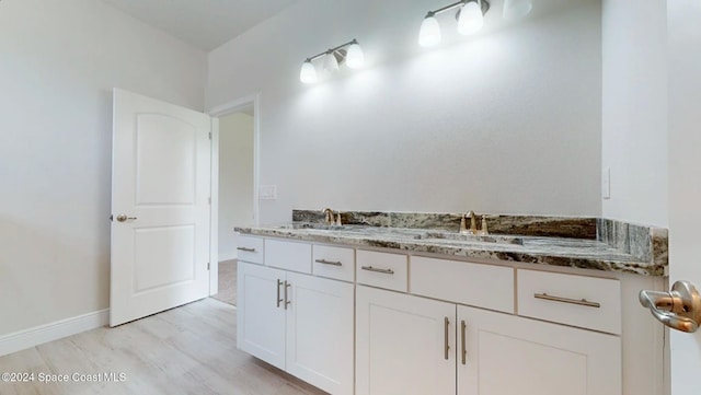 bathroom featuring vanity and hardwood / wood-style flooring