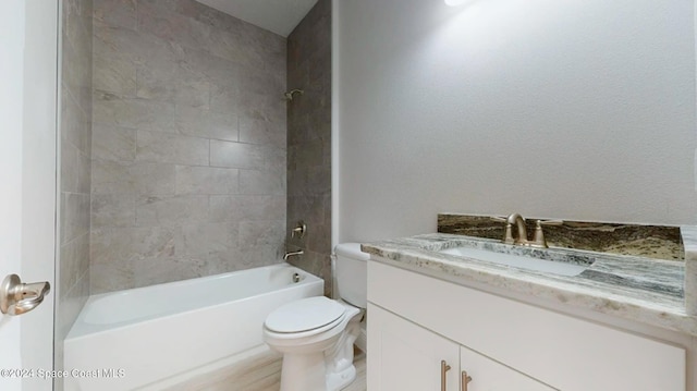 full bathroom featuring toilet, vanity, and tiled shower / bath combo