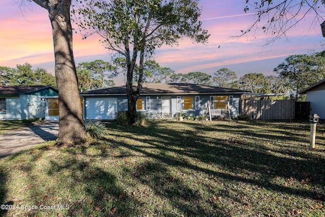 ranch-style home with a yard