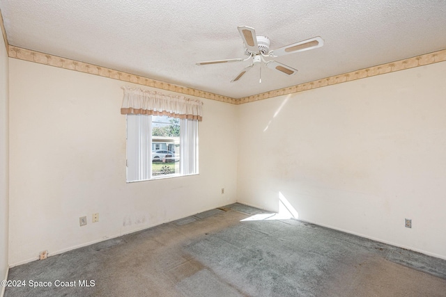 carpeted empty room featuring ceiling fan and a textured ceiling