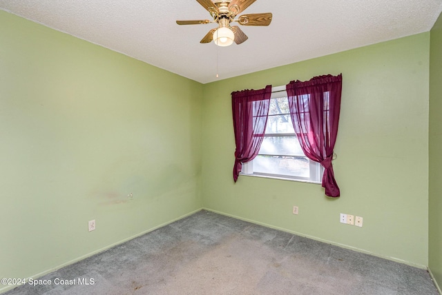 carpeted empty room with ceiling fan and a textured ceiling