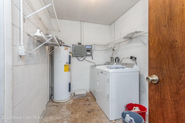 laundry area featuring a textured ceiling, electric water heater, and washing machine and clothes dryer