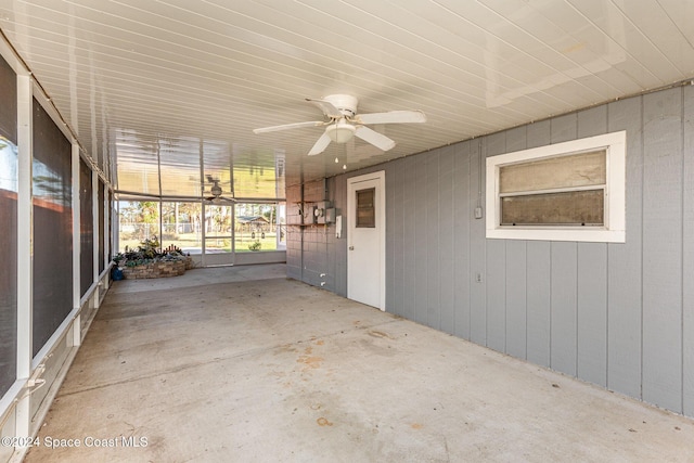 unfurnished sunroom featuring ceiling fan