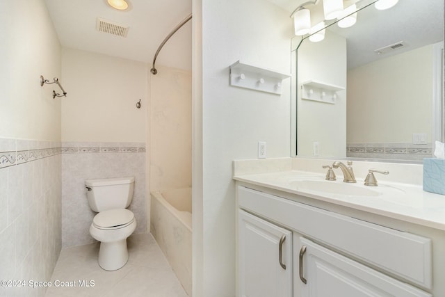 full bathroom with vanity, tile patterned floors, toilet, tile walls, and shower / bathtub combination