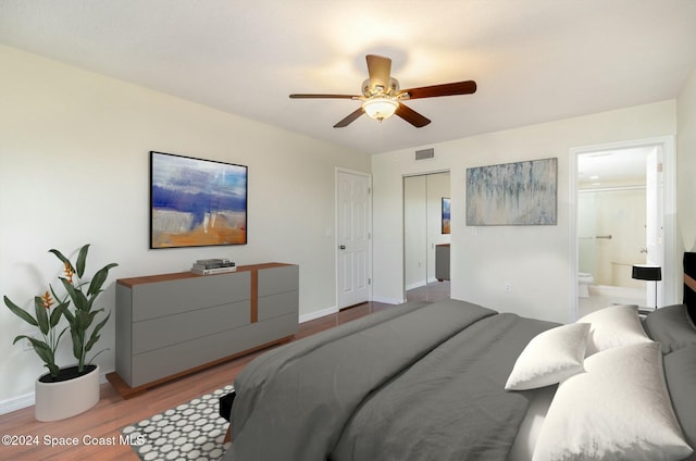 bedroom featuring ensuite bath, ceiling fan, a closet, and light hardwood / wood-style floors