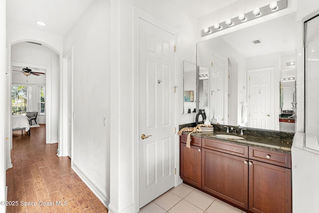 bathroom featuring ceiling fan and vanity