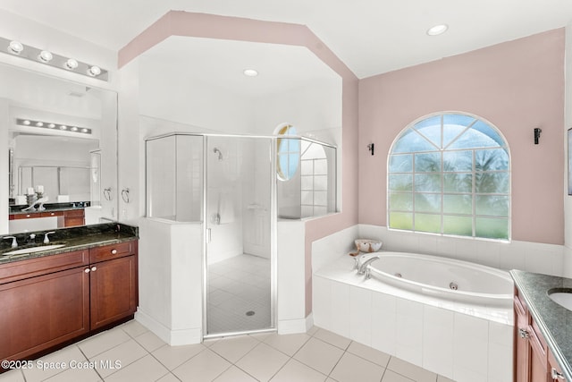 bathroom with tile patterned floors, vanity, and independent shower and bath