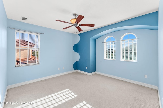 carpeted spare room with ceiling fan